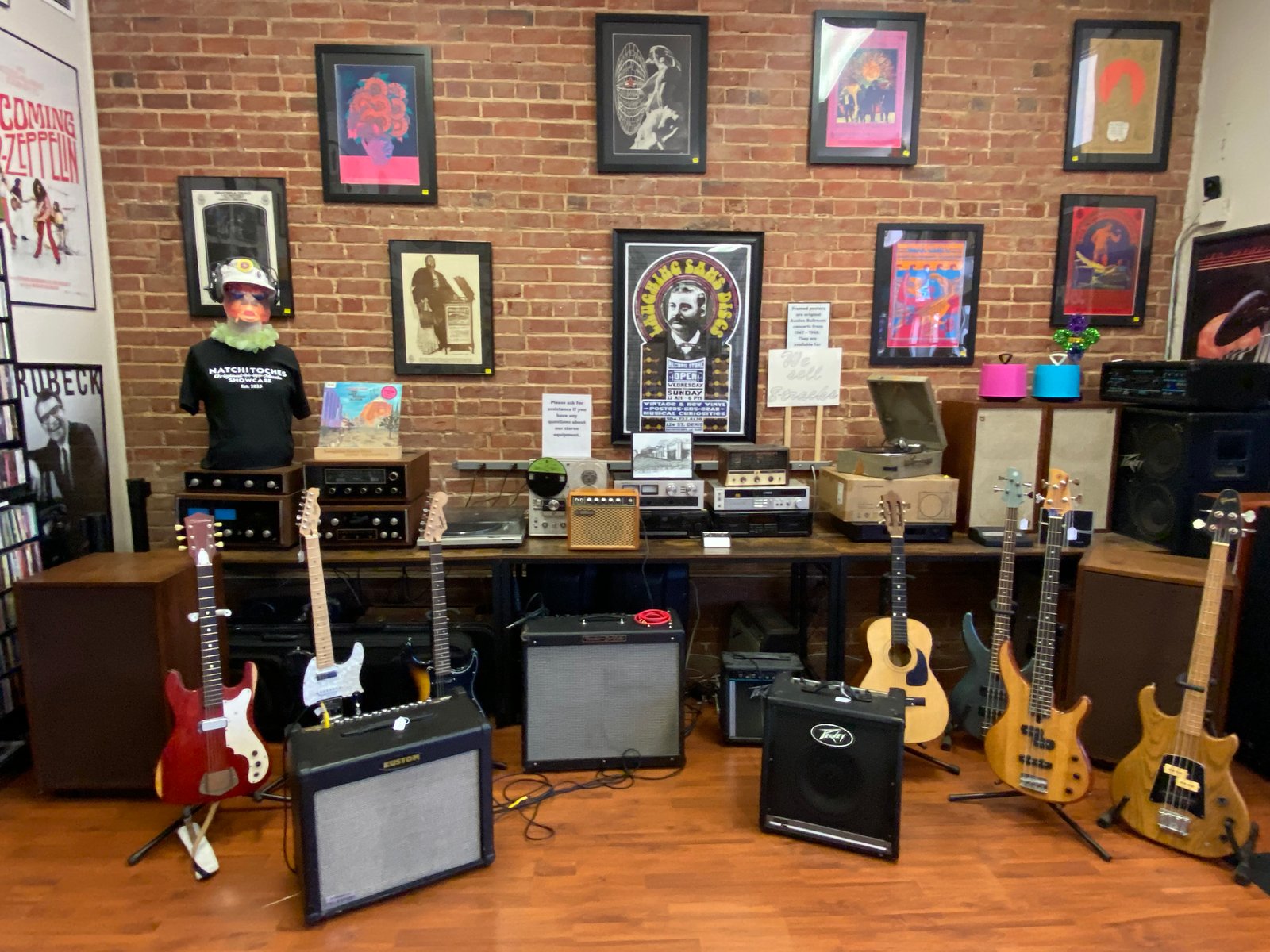 Entry area at Laughing Sam's Discs — vinyl records as wall art, Stringjoy banner